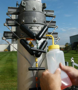 When preparing the mast for freezing weather conditions, proper eye protection must be worn and a sufficient clearance from adjacent structures, vehicles, and people must be maintained. Some of the steps in this procedure cause water, antifreeze, or lubricant to be squirted out the mast weep holes and onto adjacent areas. A drain kit is available for the base tube to route the base tube water out a drain hose. However, water can still be released from the weep holes and collars on the upper tubes. 